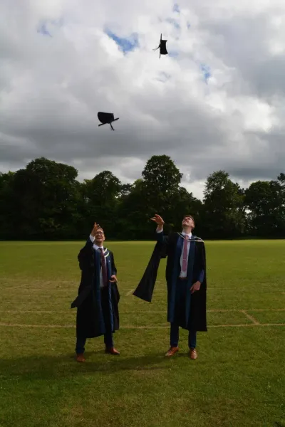 Peter graduating, throwing his cap in the air