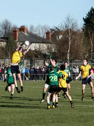 Peter fielding a high ball in the yellow DCU jersey